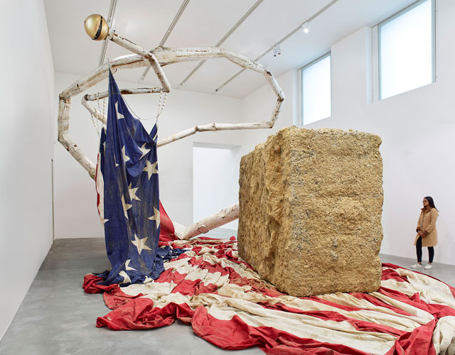 Dan Colen. The Big Kahuna, 2010-17. Concrete, steel flagpole, paint, American flag, aluminum, plastic beads, steel cable, dimensions variable. Photograph: Prudence Cumings Associates. Copyright by Dan Colen and Victor Mara Ltd.