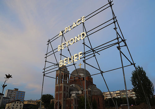 Nathan Coley. A Place Beyond Belief, 2012. Illuminated text on scaffolding, 6 × 6 × 3 m. Installation, National Gallery of Kosovo, Pristina.